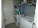 Bright laundry room with washer, dryer, and ample shelving at 23092 Sw Nautilus Blvd, Dunnellon, FL 34431