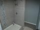 Modern shower with gray tile and glass enclosure at 23092 Sw Nautilus Blvd, Dunnellon, FL 34431