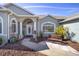 House entrance with columns, landscaping, and a walkway at 2330 Nw 59Th Ave, Ocala, FL 34482