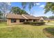 Front view of a single-story house with a brown roof and well-manicured lawn at 2540 Se 35Th St, Ocala, FL 34471