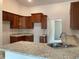 Kitchen with granite countertops and dark wood cabinets at 3 Olive Way, Ocala, FL 34472