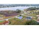 Aerial view of a single story home, fenced yard, and partial lake view at 331 Oak Lane Dr, Ocala, FL 34472