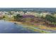 An aerial view showcasing a lake surrounded by lush greenery and residences at 331 Oak Lane Dr, Ocala, FL 34472