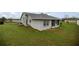 View of the home's backyard, with its spacious lawn, and the exterior of the house at 331 Oak Lane Dr, Ocala, FL 34472