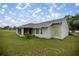 Spacious backyard featuring lush lawn and a screened patio, perfect for outdoor activities and relaxation at 331 Oak Lane Dr, Ocala, FL 34472