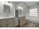 Bright bathroom with dual sink vanity, storage cabinet, and tile flooring at 331 Oak Lane Dr, Ocala, FL 34472