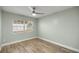 Bedroom featuring wood look tile flooring, neutral walls, and a bright window at 331 Oak Lane Dr, Ocala, FL 34472