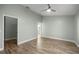 Comfortable bedroom featuring modern ceiling fan, wood-look tile floor, and ample natural light at 331 Oak Lane Dr, Ocala, FL 34472