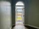 Home's entryway with a view of the lake, featuring tile flooring and a decorative door at 331 Oak Lane Dr, Ocala, FL 34472