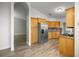 Well-lit kitchen featuring stainless steel refrigerator, wood cabinetry, and granite countertops at 331 Oak Lane Dr, Ocala, FL 34472
