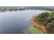 Scenic aerial view of a lake, showcasing the surrounding vegetation and clear blue water at 331 Oak Lane Dr, Ocala, FL 34472