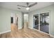 View of the light-filled living area and connecting covered patio with wood-look tile flooring at 331 Oak Lane Dr, Ocala, FL 34472