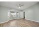 Serene main bedroom with wood-look floors, a ceiling fan, and a bright bay window at 331 Oak Lane Dr, Ocala, FL 34472