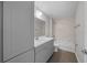 Bathroom with gray vanity, white bathtub, and marble-look walls at 3444 Se 139 Ln, Summerfield, FL 34491