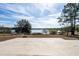 Large backyard with lake view and concrete patio at 4 Hickory Track Trce, Ocala, FL 34472