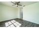 Bright bedroom with gray laminate wood flooring and ceiling fan at 4 Hickory Track Trce, Ocala, FL 34472