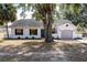 Newly renovated home with gray garage door and white exterior at 4 Hickory Track Trce, Ocala, FL 34472