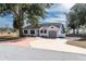 Newly renovated home with gray garage door and white exterior at 4 Hickory Track Trce, Ocala, FL 34472