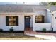 Front entrance with gray door and landscaping at 4 Hickory Track Trce, Ocala, FL 34472