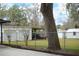 Spacious backyard with detached garage, shed, and mature trees at 404 Cr 487, Lake Panasoffkee, FL 33538