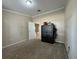 Bedroom with tan carpet, a safe, and door to the hallway at 404 Cr 487, Lake Panasoffkee, FL 33538