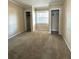 Bedroom with tan carpet, window, and closets with wire rack shelving at 404 Cr 487, Lake Panasoffkee, FL 33538