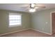 Bedroom with carpet flooring, neutral walls, and a ceiling fan and window at 404 Cr 487, Lake Panasoffkee, FL 33538