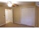 Bedroom features a ceiling fan and a double door closet at 404 Cr 487, Lake Panasoffkee, FL 33538