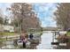 Peaceful waterfront view with boats and lush vegetation at 404 Cr 487, Lake Panasoffkee, FL 33538