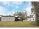 Two-car garage with covered carport and ample space at 404 Cr 487, Lake Panasoffkee, FL 33538