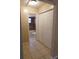 Hallway view to bathroom with closet on right and tile flooring at 404 Cr 487, Lake Panasoffkee, FL 33538