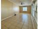 Living room with neutral paint, tile flooring, ceiling fan, and a large window at 404 Cr 487, Lake Panasoffkee, FL 33538