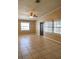 Living room with neutral paint, tile flooring, ceiling fan, and multiple windows at 404 Cr 487, Lake Panasoffkee, FL 33538