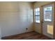 This room features wood plank flooring, and a window and door allow for natural light at 404 Cr 487, Lake Panasoffkee, FL 33538