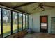 Sunroom features large windows offering views of the backyard, perfect for relaxation and natural light at 404 Cr 487, Lake Panasoffkee, FL 33538