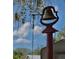 An outdoor bell adds a touch of old-world charm to the property and surrounding landscape at 404 Cr 487, Lake Panasoffkee, FL 33538