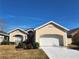 Single-story home with a two-car garage and manicured lawn at 4117 Sw 30Th Ct, Ocala, FL 34474