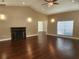 Spacious living room featuring hardwood floors, a fireplace, and vaulted ceilings at 4117 Sw 30Th Ct, Ocala, FL 34474