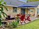 Relaxing backyard patio with seating area, umbrella, and lush landscaping at 4360 Se 62Nd St, Ocala, FL 34480