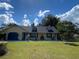 Charming yellow house with blue accents, landscaped yard, and a spacious front porch at 4360 Se 62Nd St, Ocala, FL 34480