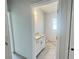 Bright bathroom featuring a granite vanity top, modern white cabinets, and tile flooring at 4373 Sw 90Th Pl, Ocala, FL 34476