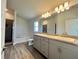 This bathroom features a double vanity, soaking tub, and wooden-look tiled floor at 4373 Sw 90Th Pl, Ocala, FL 34476