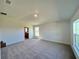 Spacious bedroom with neutral carpet, high ceiling, and natural light streaming through the windows at 4373 Sw 90Th Pl, Ocala, FL 34476