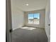 Carpeted bedroom with a large window, neutral walls, and a view of the neighborhood at 4373 Sw 90Th Pl, Ocala, FL 34476