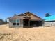 New home construction featuring concrete block walls, a 2-car garage, and a modern roof design at 4373 Sw 90Th Pl, Ocala, FL 34476