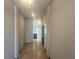 Hallway featuring stylish tiled flooring, fresh neutral paint, and direct access to the home's living space at 4373 Sw 90Th Pl, Ocala, FL 34476