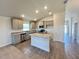 Modern kitchen with stainless steel appliances, a center island, and neutral-colored cabinets at 4373 Sw 90Th Pl, Ocala, FL 34476