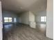 Open living area with wood-look tile floors and a view into the kitchen at 4429 Sw 90Th Pl, Ocala, FL 34476