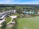 Aerial view of clubhouse, pool, landscaping, and a lake at 5365 Nw 46Th Lane Rd, Ocala, FL 34482