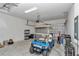 Garage with golf cart, storage shelving, and overhead door at 5365 Nw 46Th Lane Rd, Ocala, FL 34482